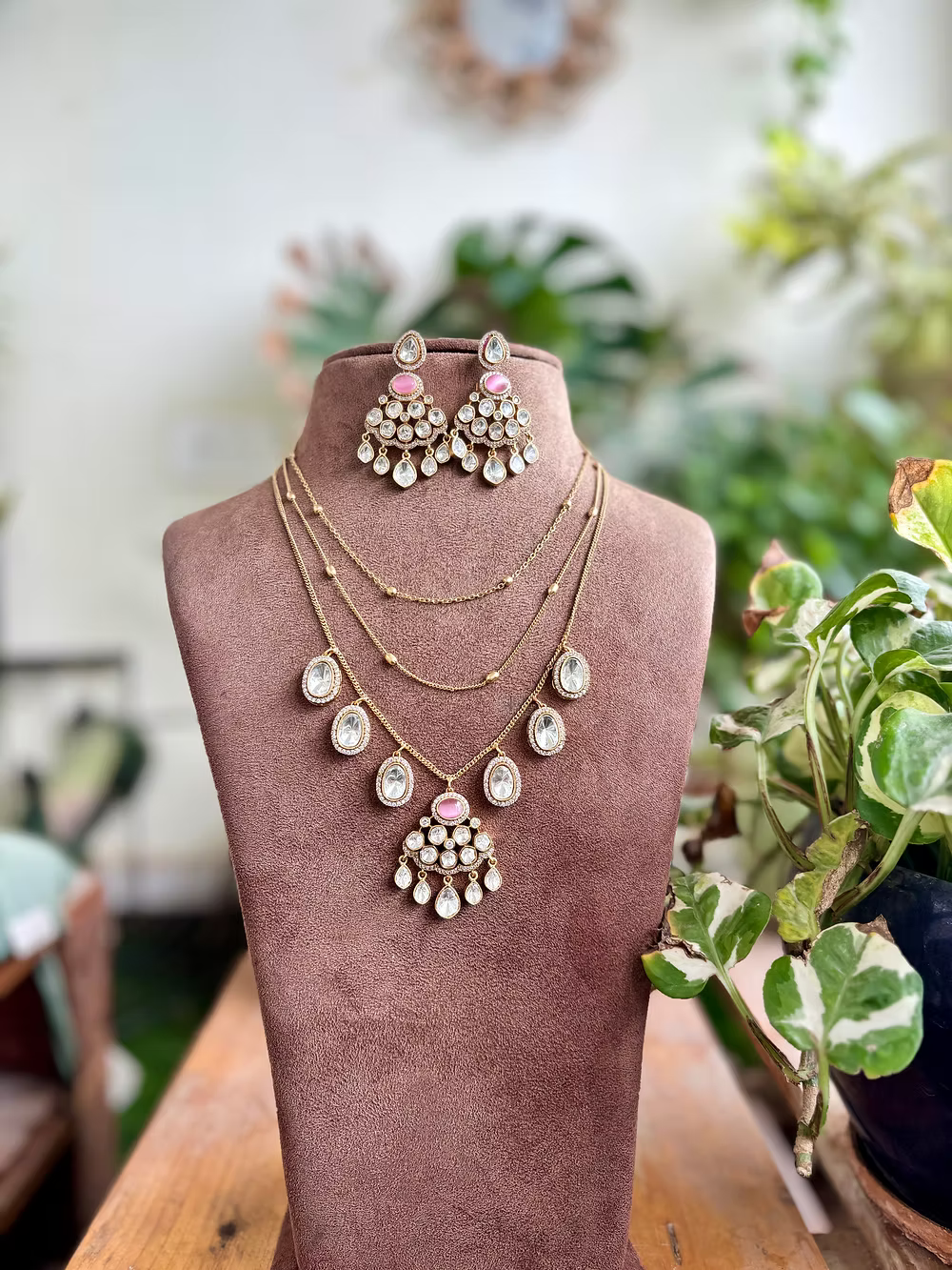 Jewelry set on a mannequin bust with a blurred natural background